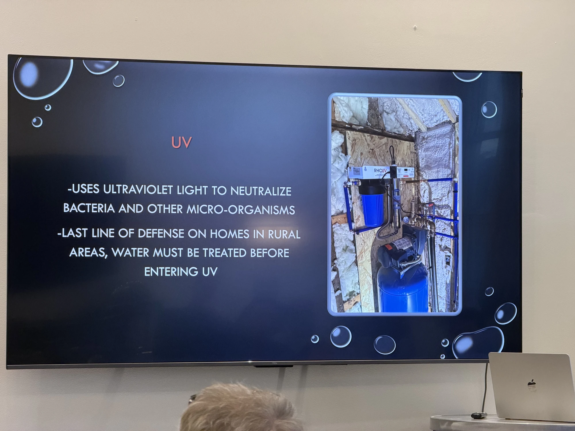 King Plumbing presentation slide showing UV water treatment and an installation photograph